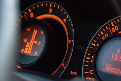 Closeup of the Toyota Auris fuel consumption sign in a car with orange lights